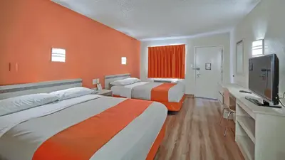 a hotel room with two beds and a flat screen tv at Motel 6-Maple Shade Township, NJ - Philadelphia - Mt Laurel in Maple Shade
