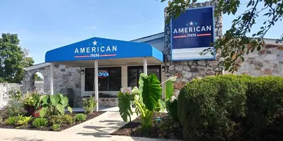 a american inn sign in front of a building at American Inn in Carlisle