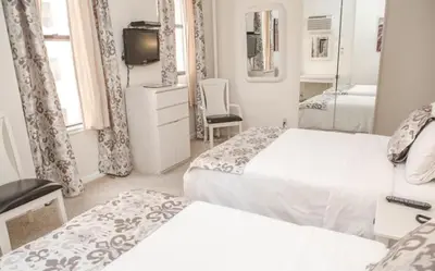 a hotel room with two beds and a television at Da Vinci Hotel in New York