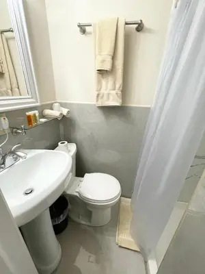 a bathroom with a white toilet and a sink at Da Vinci Hotel in New York