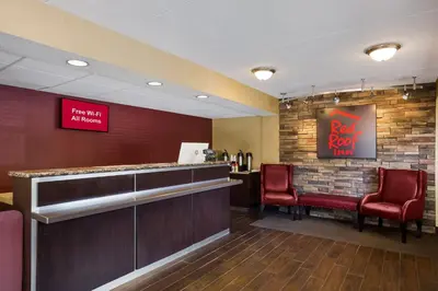a bar at a red roof restaurant with red chairs at Red Roof Inn Wilkes-Barre Arena in Wilkes-Barre