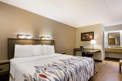 a hotel room with a bed and a desk at Red Roof Inn Wilkes-Barre Arena in Wilkes-Barre