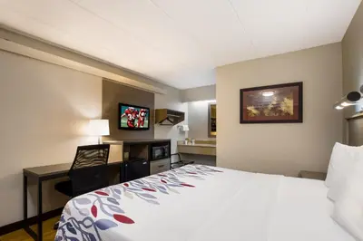 a hotel room with a bed and a desk at Red Roof Inn Wilkes-Barre Arena in Wilkes-Barre