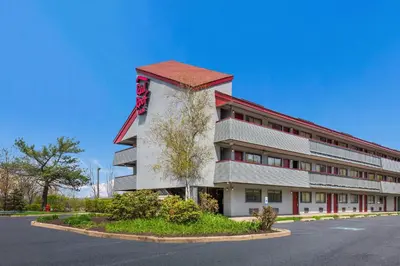 a large white building with a red roof at Red Roof Inn Wilkes-Barre Arena in Wilkes-Barre