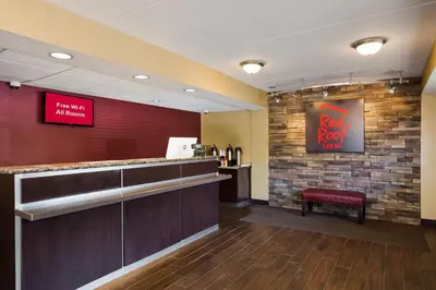 a bar with a red sign on a brick wall at Red Roof Inn Wilkes-Barre Arena in Wilkes-Barre
