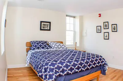 a bedroom with a bed with a blue and white comforter at ⭐️Trendy Apartment⭐️Fishtown⭐️ in Philadelphia