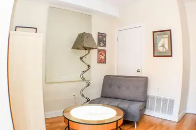 a living room with a chair and a table at ⭐️Trendy Apartment⭐️Fishtown⭐️ in Philadelphia