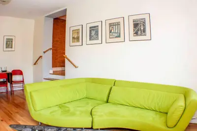 a green couch sitting in a living room at ⭐️Trendy Apartment⭐️Fishtown⭐️ in Philadelphia