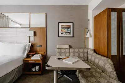 a hotel room with a bed and a couch and a desk at Club Quarters Hotel Grand Central, New York in New York
