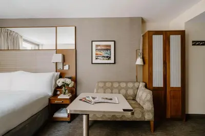 a hotel room with a bed and a couch at Club Quarters Hotel Grand Central, New York in New York