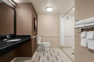 a bathroom with a toilet and a sink at Fairfield Inn & Suites by Marriott Hershey Chocolate Avenue in Hershey