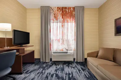 a hotel room with a couch and a window at Fairfield Inn & Suites by Marriott Hershey Chocolate Avenue in Hershey