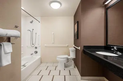 a bathroom with a toilet and a sink and a bath tub at Fairfield Inn & Suites by Marriott Hershey Chocolate Avenue in Hershey