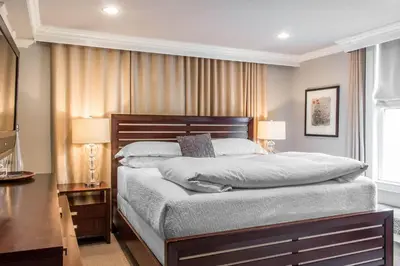 a bedroom with a large bed and two lamps at The Peacock Inn, an Ascend Collection Hotel in Princeton