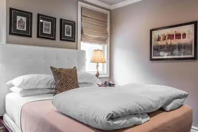 a bedroom with a large white bed and a lamp at The Peacock Inn, an Ascend Collection Hotel in Princeton