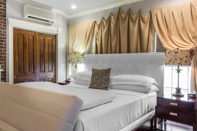a bedroom with a large white bed and curtains at The Peacock Inn, an Ascend Collection Hotel in Princeton