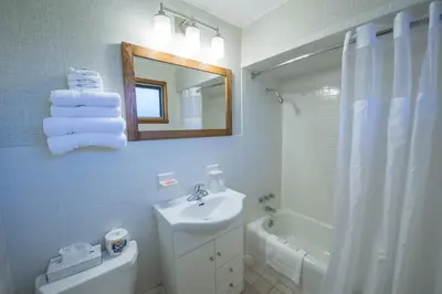 a bathroom with a sink and a toilet and a mirror at Lukans Farm Resort in Hawley