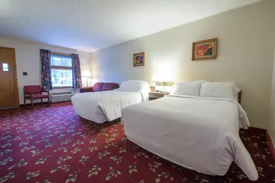 a hotel room with two beds and a red carpet at Lukans Farm Resort in Hawley