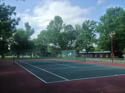 a tennis court with a net on top of it at Lukans Farm Resort in Hawley