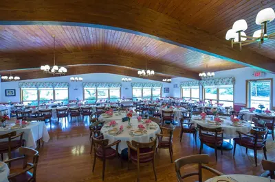 a banquet hall with white tables and chairs at Lukans Farm Resort in Hawley