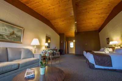 a hotel room with a bed and a couch at Lukans Farm Resort in Hawley