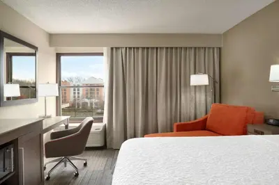 a hotel room with a bed and a desk and a window at Hampton Inn Philadelphia/Mt. Laurel in Mount Laurel