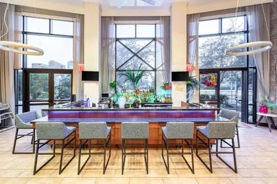 a large dining room with a blue table and chairs at Hampton Inn & Suites Newark-Harrison-Riverwalk in Newark