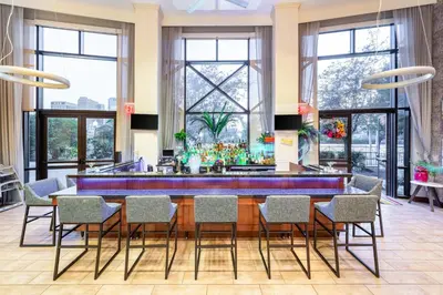 a large dining room with a long blue table and chairs at Hampton Inn & Suites Newark-Harrison-Riverwalk in Newark