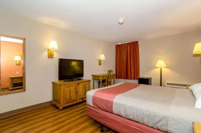 a hotel room with a bed and a flat screen tv at Motel 6-Newark, DE in Newark