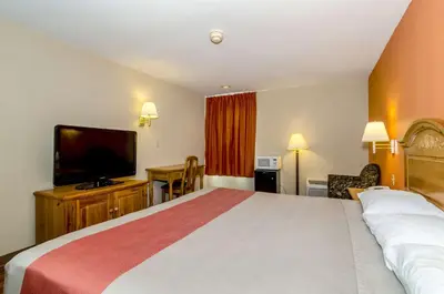 a hotel room with a bed and a flat screen tv at Motel 6-Newark, DE in Newark