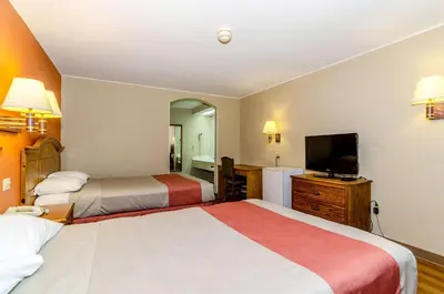 a hotel room with two beds and a flat screen tv at Motel 6-Newark, DE in Newark