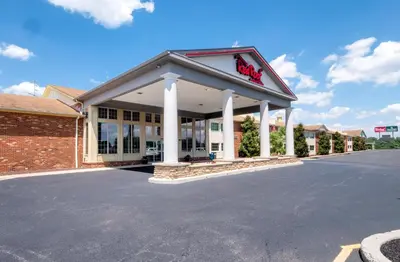 a building with a krispy kreme sign on it at Red Roof Inn & Suites Wilmington – New Castle in New Castle