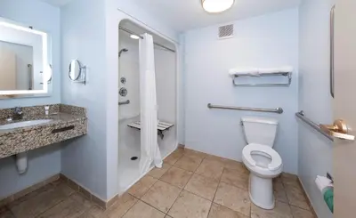a bathroom with a toilet and a sink at Red Roof Inn & Suites Wilmington – New Castle in New Castle