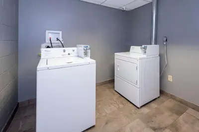 a laundry room with a washer and a dryer at Red Roof Inn & Suites Wilmington – New Castle in New Castle