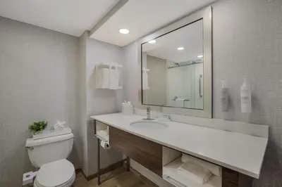 a bathroom with a sink and a toilet and a mirror at Hampton Inn Philadelphia/Willow Grove in Willow Grove