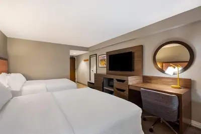 a hotel room with a bed and a desk with a television at Hampton Inn Philadelphia/Willow Grove in Willow Grove