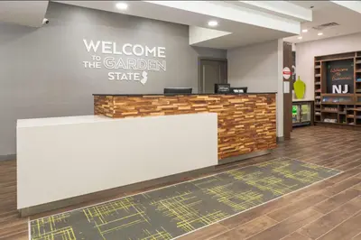a lobby with a welcome to the garden state sign on a wall at Hampton Inn Swedesboro Philadelphia in Swedesboro