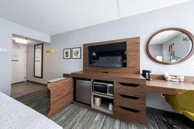 a hotel room with a bed and a television at Hampton Inn Swedesboro Philadelphia in Swedesboro