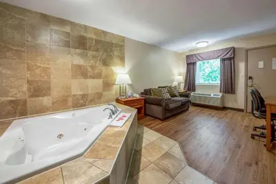 a large bathroom with a tub and a living room at Econo Lodge Mount Laurel - Philadelphia East in Mount Laurel