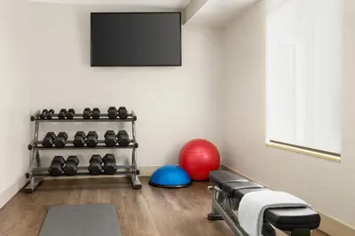 a room with a gym with a flat screen tv at Holiday Inn Express & Suites Philadelphia - Mt Laurel by IHG in Mount Laurel