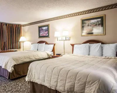 a hotel room with two beds and two lamps at Econo Lodge Newton in Newton
