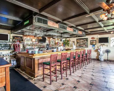 a bar with a bunch of chairs in a room at Econo Lodge Newton in Newton