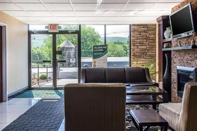a waiting room with a couch and a fireplace at Quality Inn near Mountain Creek in Vernon