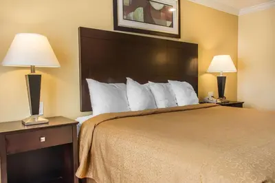 a hotel room with a large bed with two lamps at Quality Inn near Mountain Creek in Vernon