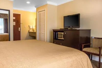 a hotel room with a bed and a flat screen tv at Quality Inn near Mountain Creek in Vernon