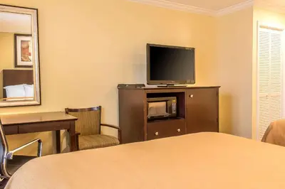 a hotel room with a bed and a flat screen tv at Quality Inn near Mountain Creek in Vernon