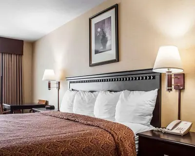 a hotel room with a bed and a telephone at Econo Lodge Elmira-Corning in Elmira