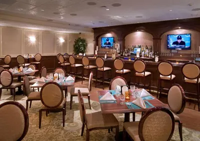 a restaurant with tables and chairs and a bar at DoubleTree by Hilton Nanuet in Nanuet