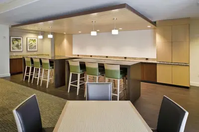 a conference room with a bar with chairs and tables at DoubleTree by Hilton Nanuet in Nanuet