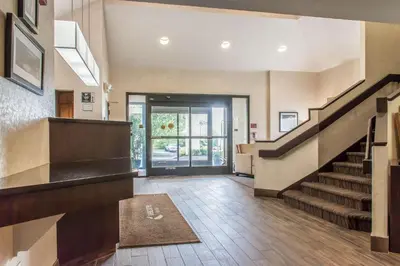 an empty lobby with a staircase and a door at Sleep Inn & Suites of Lancaster County in Mountville